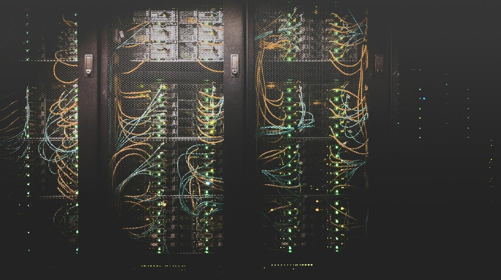 Data center server racks with network cabling and status indicator lights.