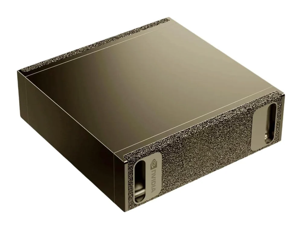 An NVIDIA DGX Spark: a small flat desktop unit in graphite and gold, with a coarse perforated intake panel across the front carrying the NVIDIA logo.